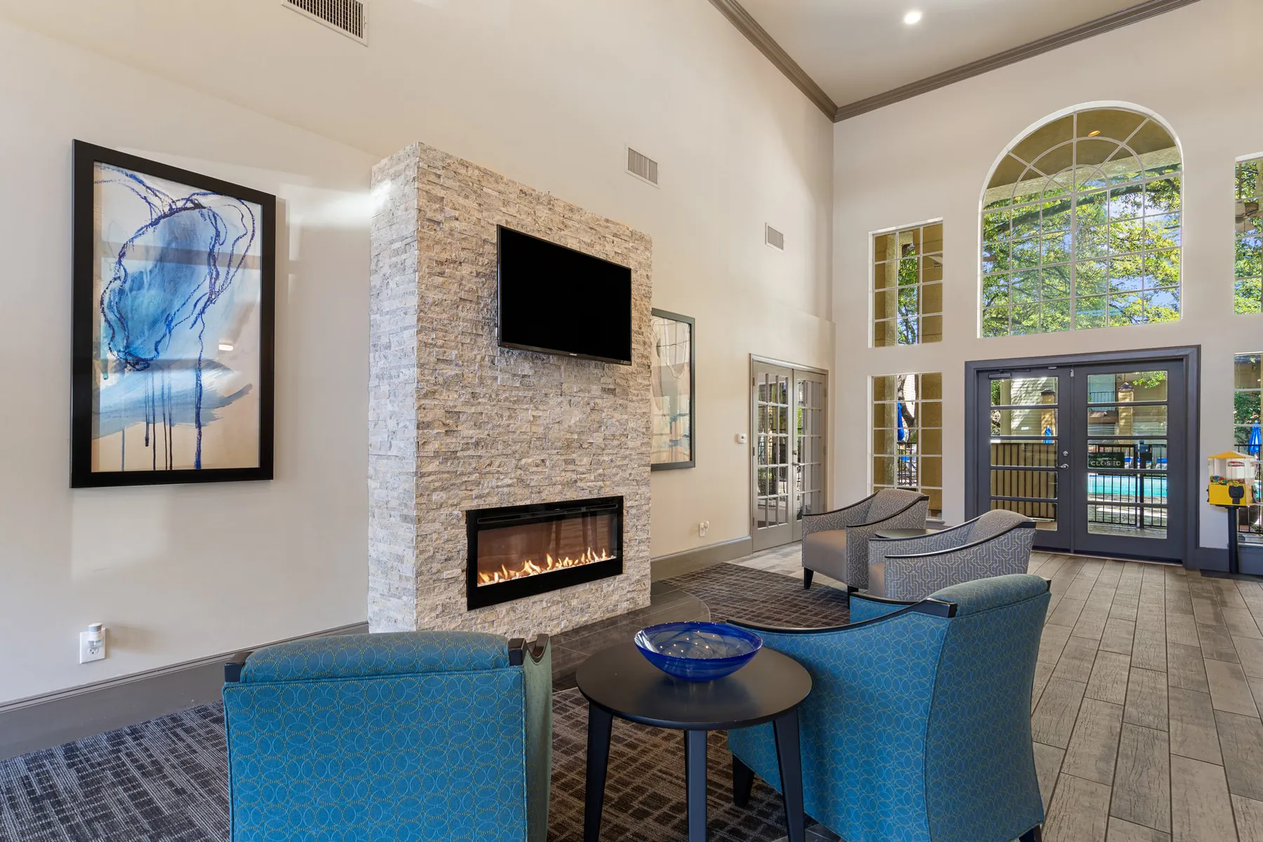 Stone fireplace seating area inside the Regal Court clubhouse