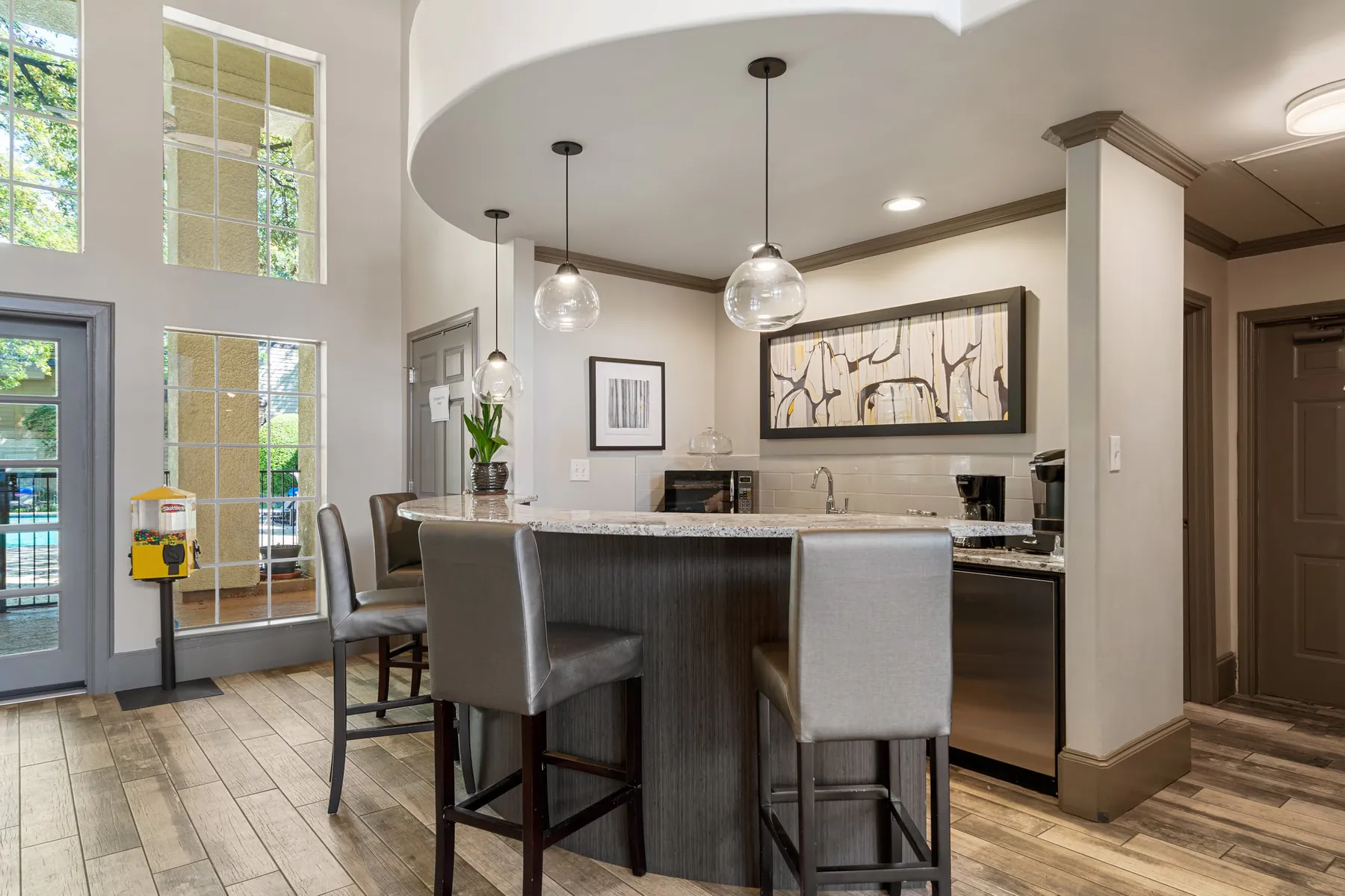 Clubhouse kitchen bar with stools and glass pendant lights at Regal Court