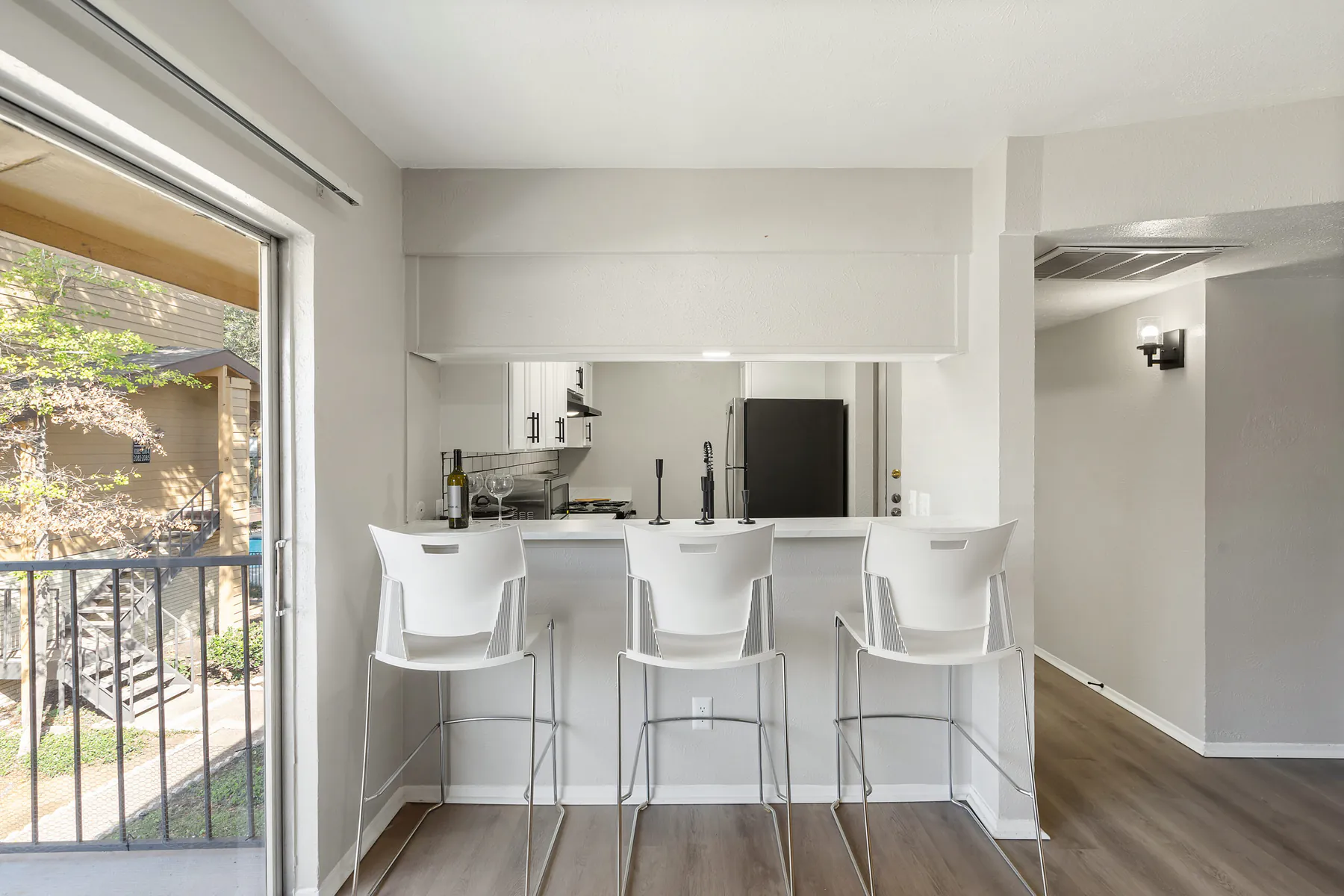 Kitchen breakfast bar beside a sliding door to the balcony at Regal Court