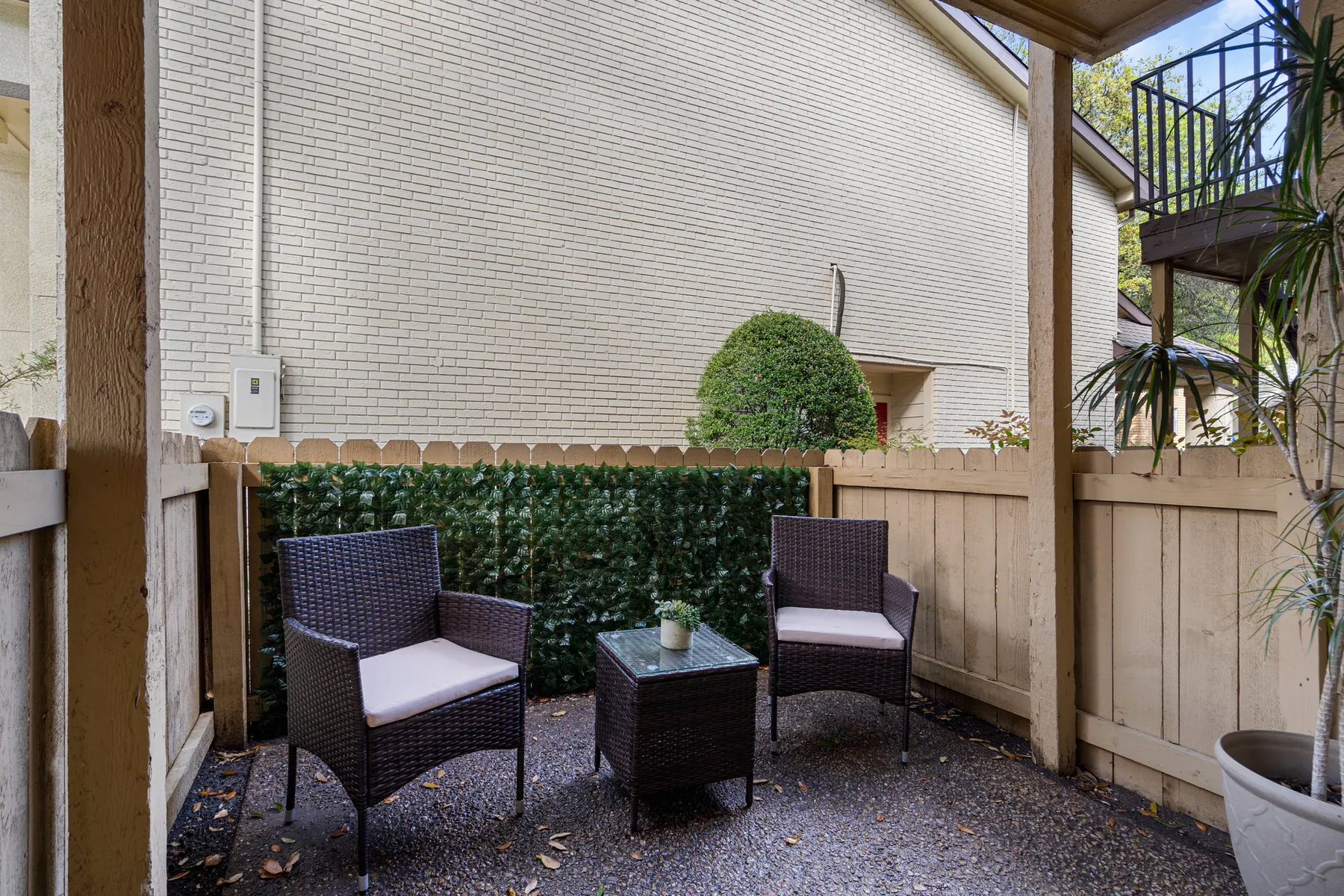 Private fenced patio with outdoor seating at Regal Court